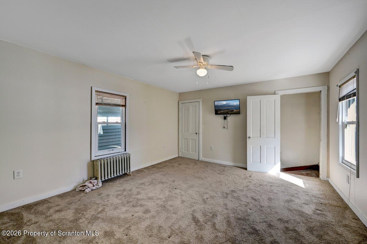 328 Ferdinand Street Scranton, PA 18508 - Photo 33 of 40 an empty room with windows and ceiling fan