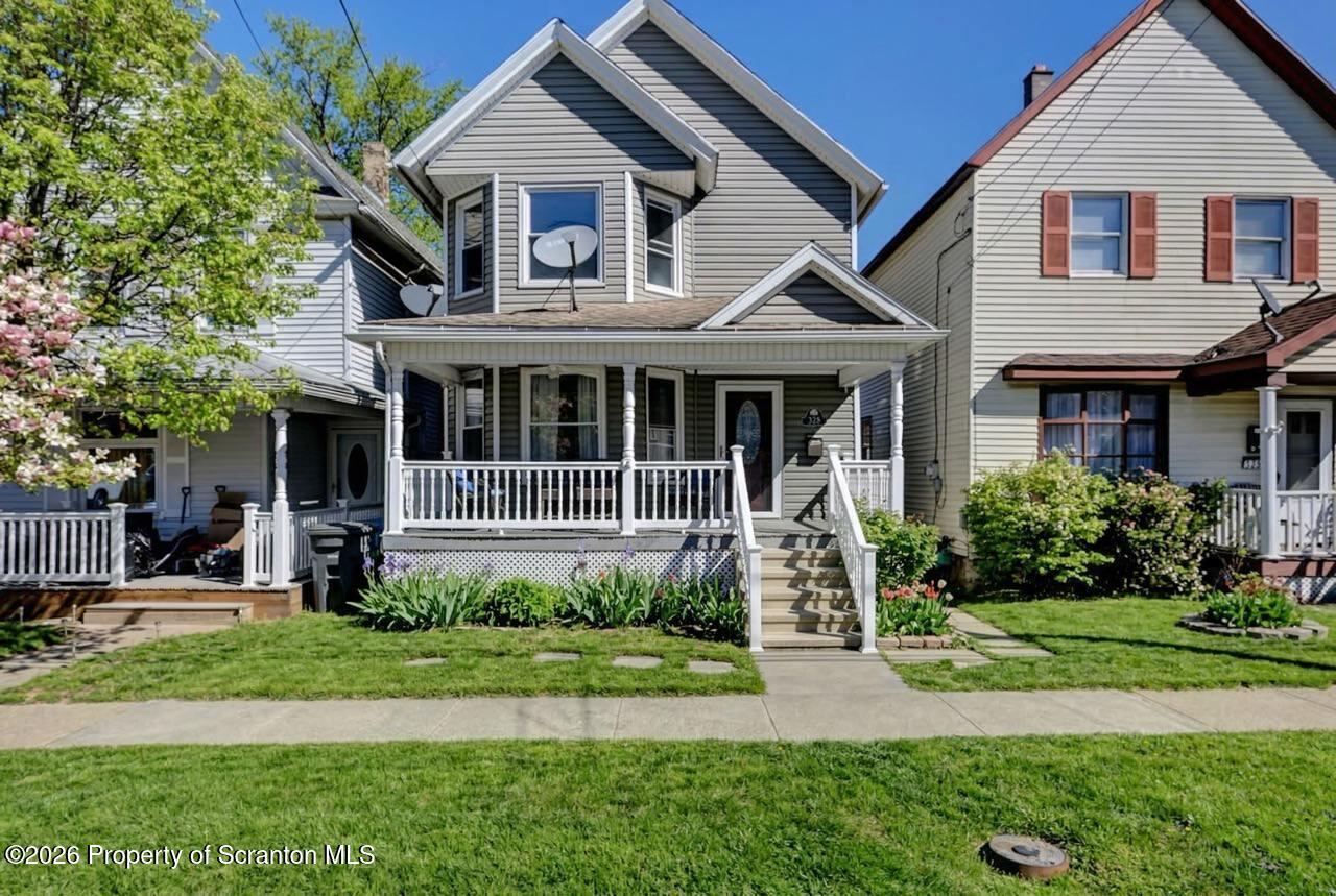 328 Ferdinand Street Scranton, PA 18508 - Photo 4 of 40 a front view of a house with a yard table and chairs