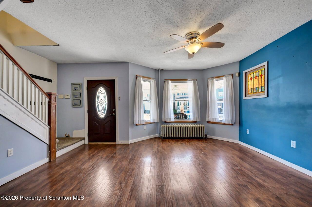 328 Ferdinand Street Scranton, PA 18508 - Photo 7 of 40 a view of an empty room with a window and wooden floor