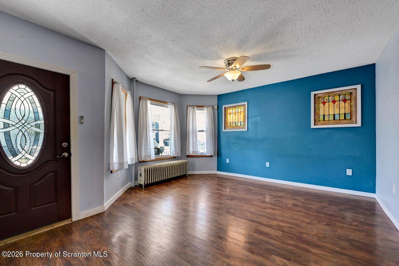 328 Ferdinand Street Scranton, PA 18508 - Photo 8 of 40 a view of livingroom with furniture entryway wooden floor and window