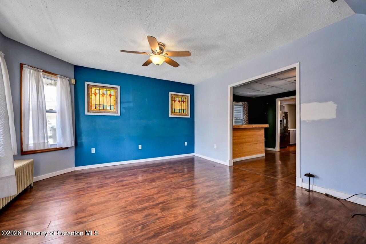 328 Ferdinand Street Scranton, PA 18508 - Photo 9 of 40 a view of an empty room with window and wooden floor