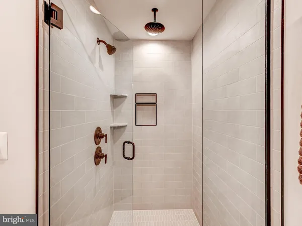 a bathroom with a shower and a mirror