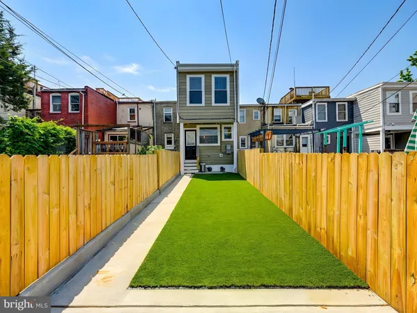 a view of front door of house with a yard
