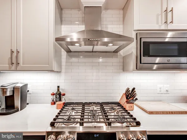 a kitchen with granite countertop a stove and a sink