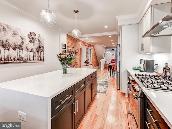 a kitchen with stainless steel appliances granite countertop a sink and a stove