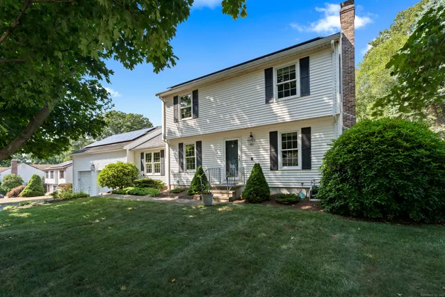 a front view of house with a garden and patio