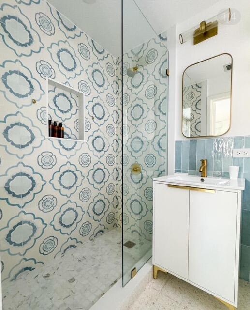 255 Cortez Road West Palm Beach, FL 33405 - Photo 13 of 24 a bathroom with a sink and mirror with painted walls