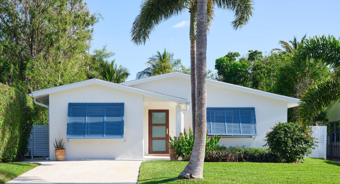 255 Cortez Road West Palm Beach, FL 33405 - Photo 2 of 24 a front view of a house with a yard and potted plants