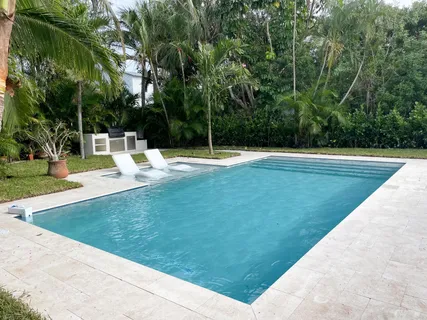 a view of a swimming pool with a yard