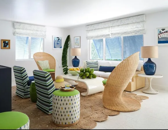 a living room with couches chandelier and a large window