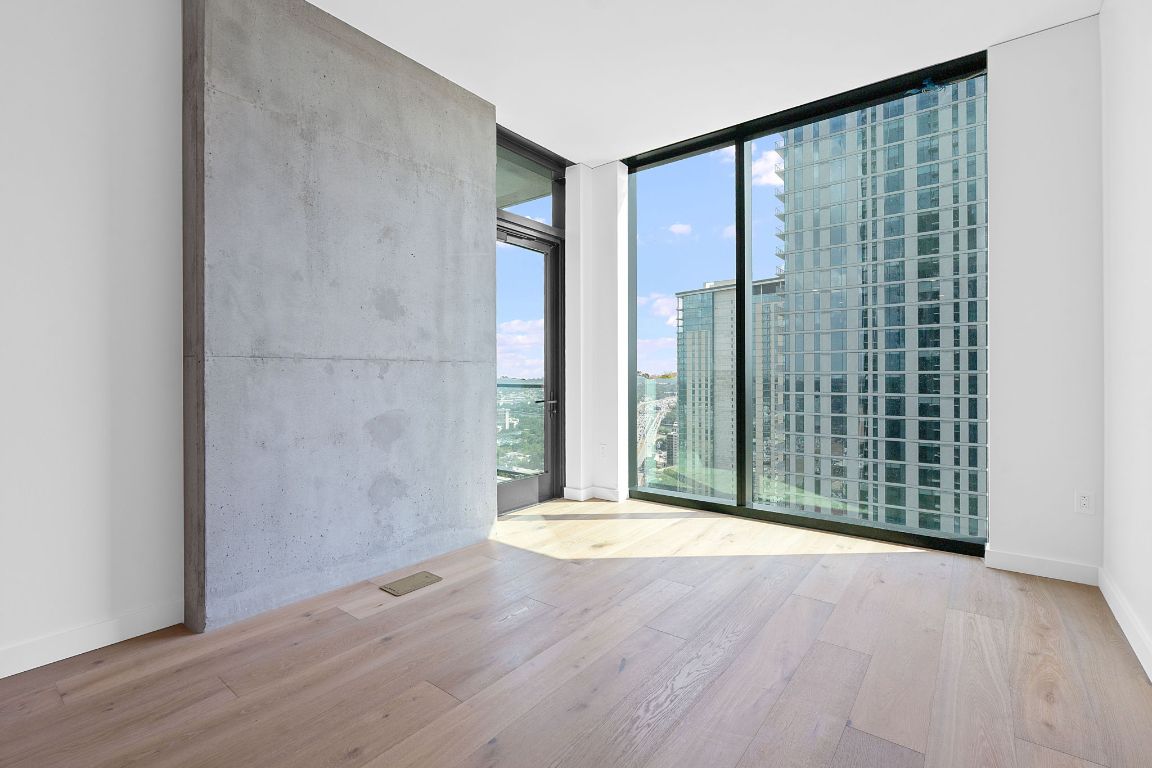610 Davis Street, Unit 3004 Austin, TX 78701 - Photo 10 of 40 a view of a room with wooden floor and windows