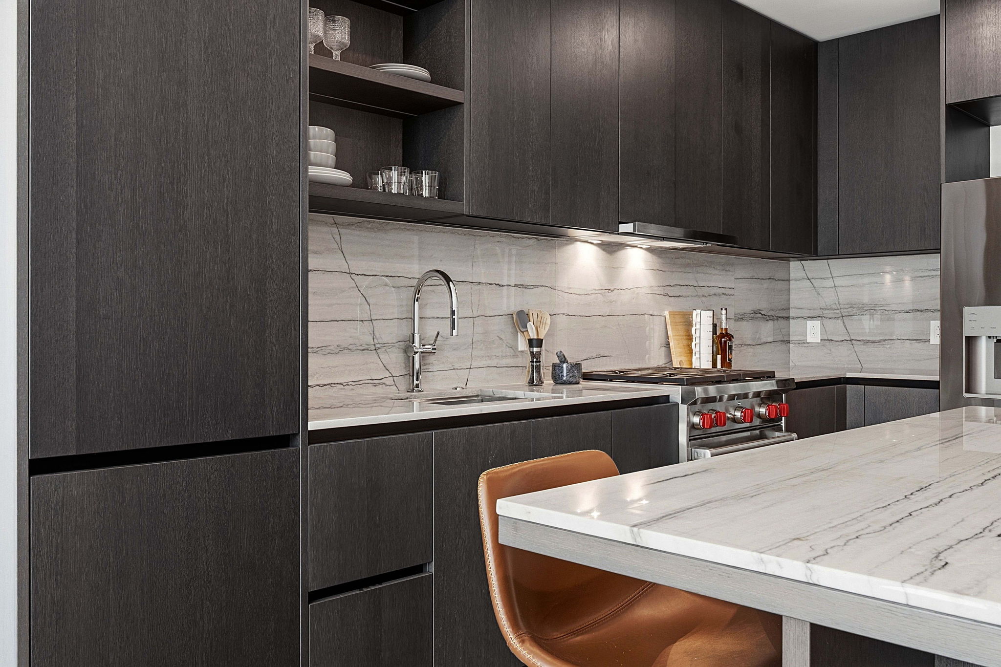 610 Davis Street, Unit 3004 Austin, TX 78701 - Photo 13 of 40 Kitchen with modern cabinets, light stone countertops, dark wood finish cabinets, and open shelves