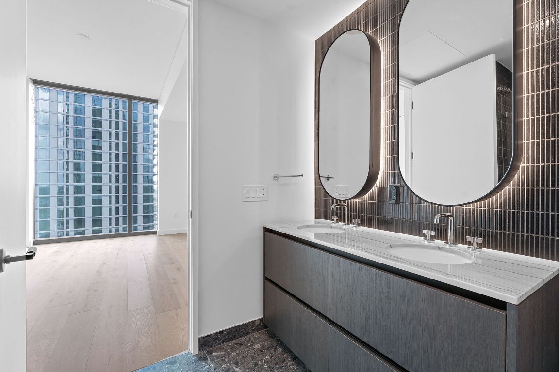 610 Davis Street, Unit 3004 Austin, TX 78701 - Photo 14 of 40 a bathroom with a double vanity sink and a mirror