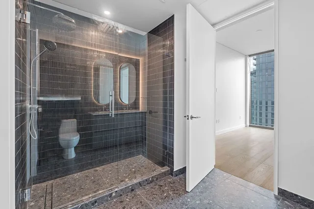 a bathroom with a shower and a toilet