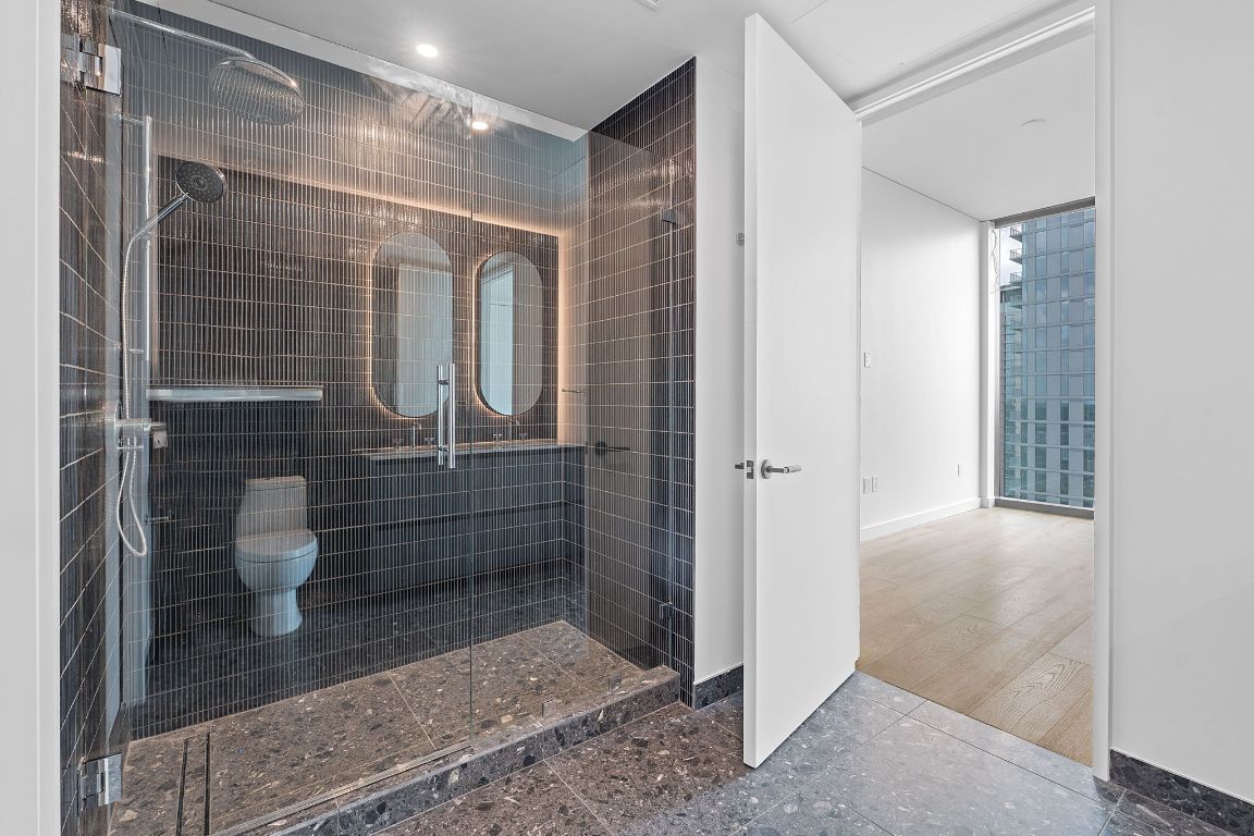 610 Davis Street, Unit 3004 Austin, TX 78701 - Photo 15 of 40 a bathroom with a shower and a toilet
