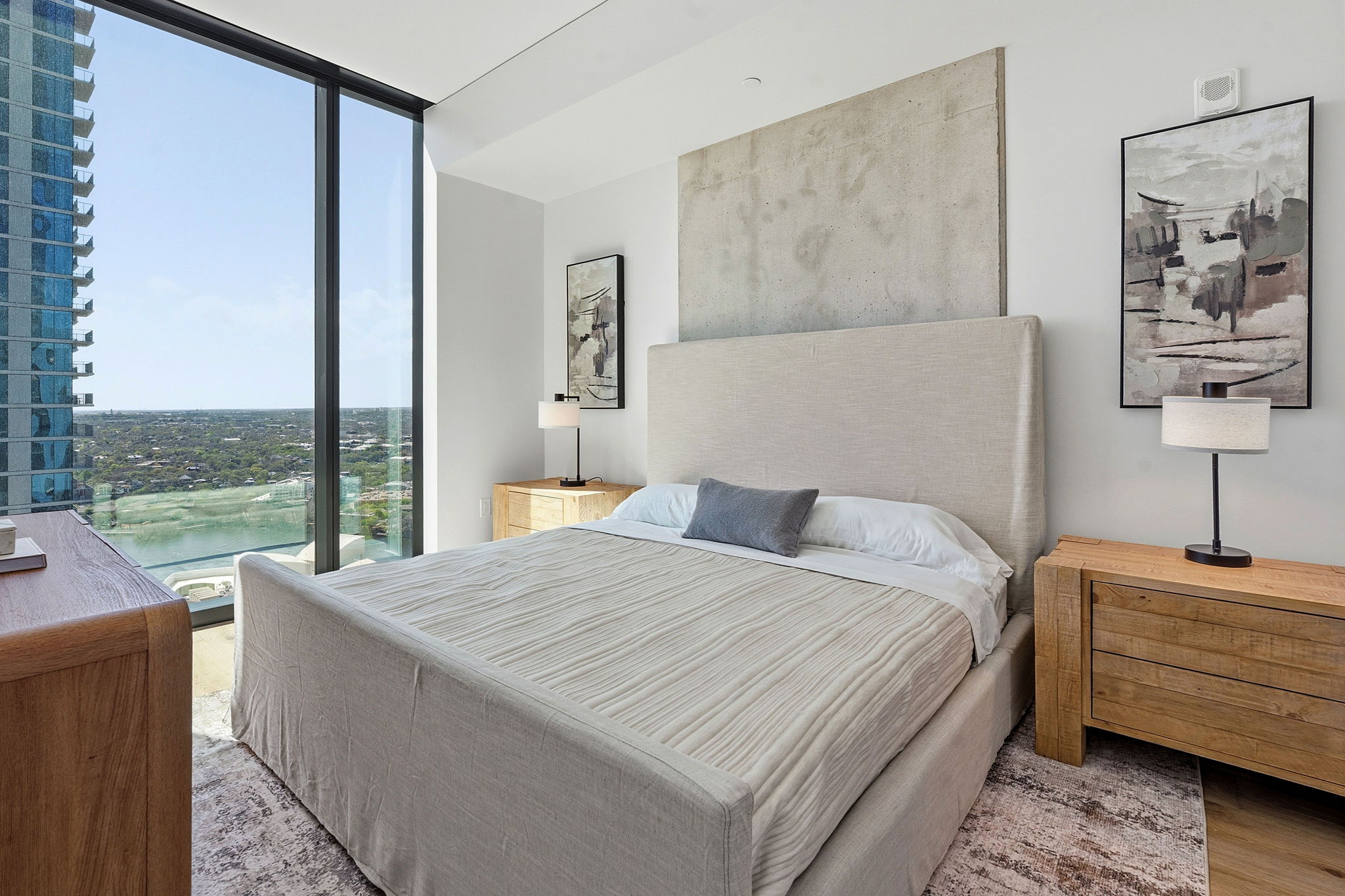 610 Davis Street, Unit 3004 Austin, TX 78701 - Photo 16 of 40 Bedroom featuring floor to ceiling windows, light wood-style floors, and a water view
