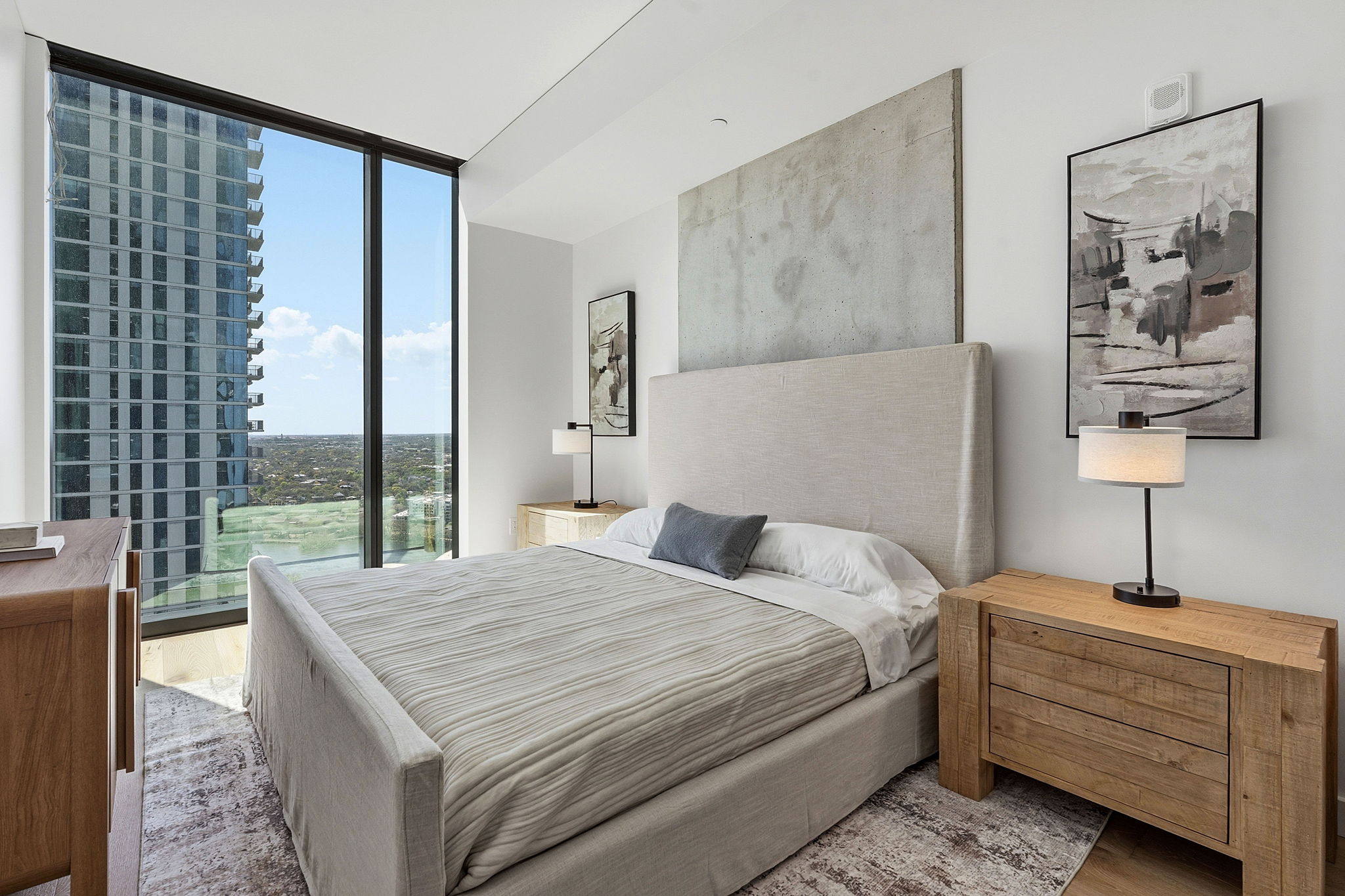 610 Davis Street, Unit 3004 Austin, TX 78701 - Photo 19 of 40 Bedroom with floor to ceiling windows, wood finished floors, and a city view