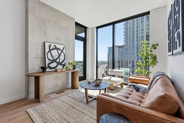 a living room with furniture and floor to ceiling window