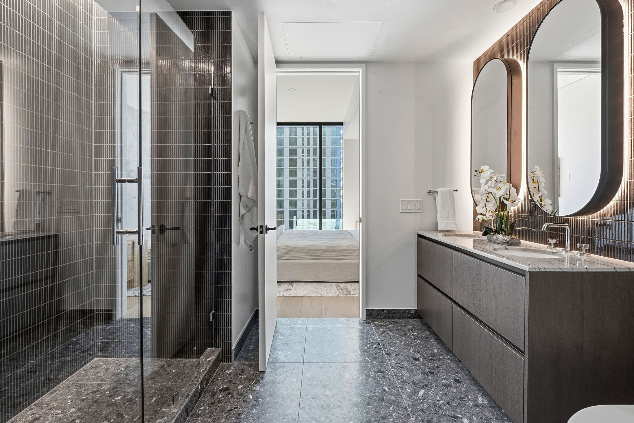610 Davis Street, Unit 3004 Austin, TX 78701 - Photo 21 of 40 Bathroom featuring a shower stall, vanity, and ensuite bathroom