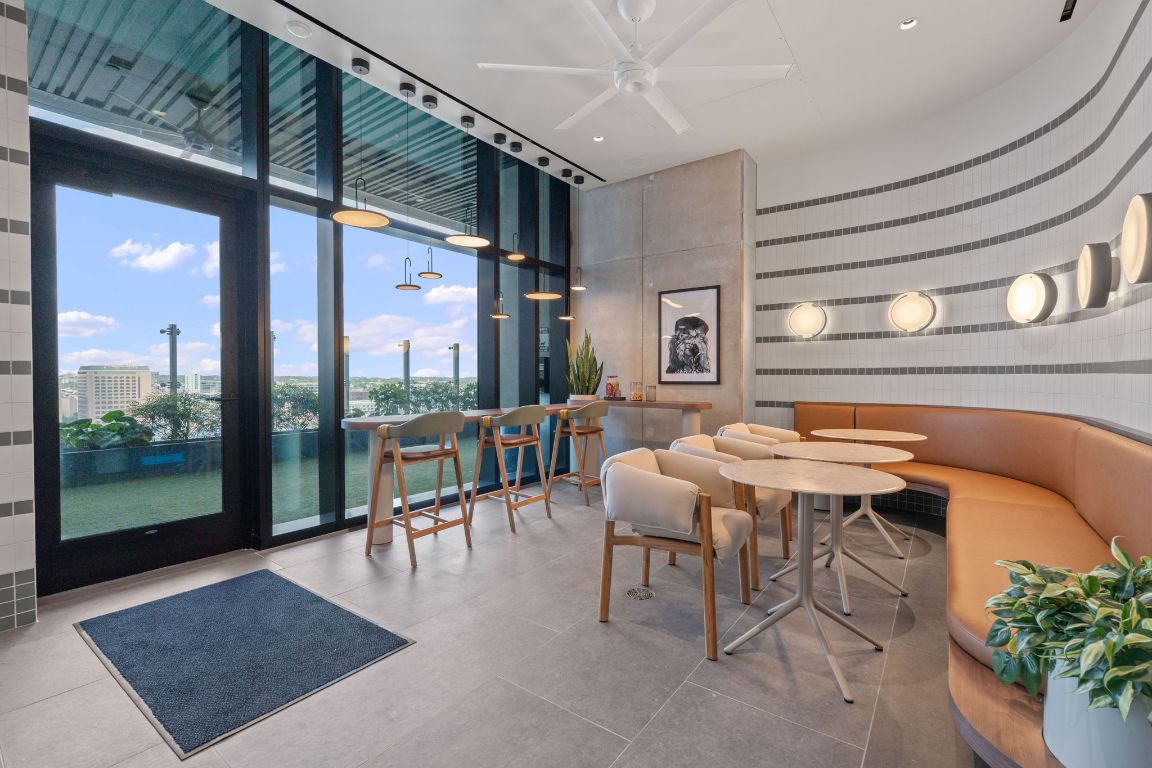 610 Davis Street, Unit 3004 Austin, TX 78701 - Photo 23 of 40 a outdoor space with lots of tables a mirror and a rug