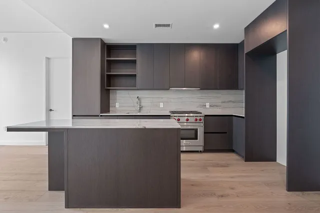 a view of kitchen with cabinets and wooden floor