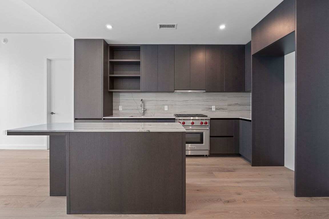 610 Davis Street, Unit 3004 Austin, TX 78701 - Photo 3 of 40 a view of kitchen with cabinets and wooden floor