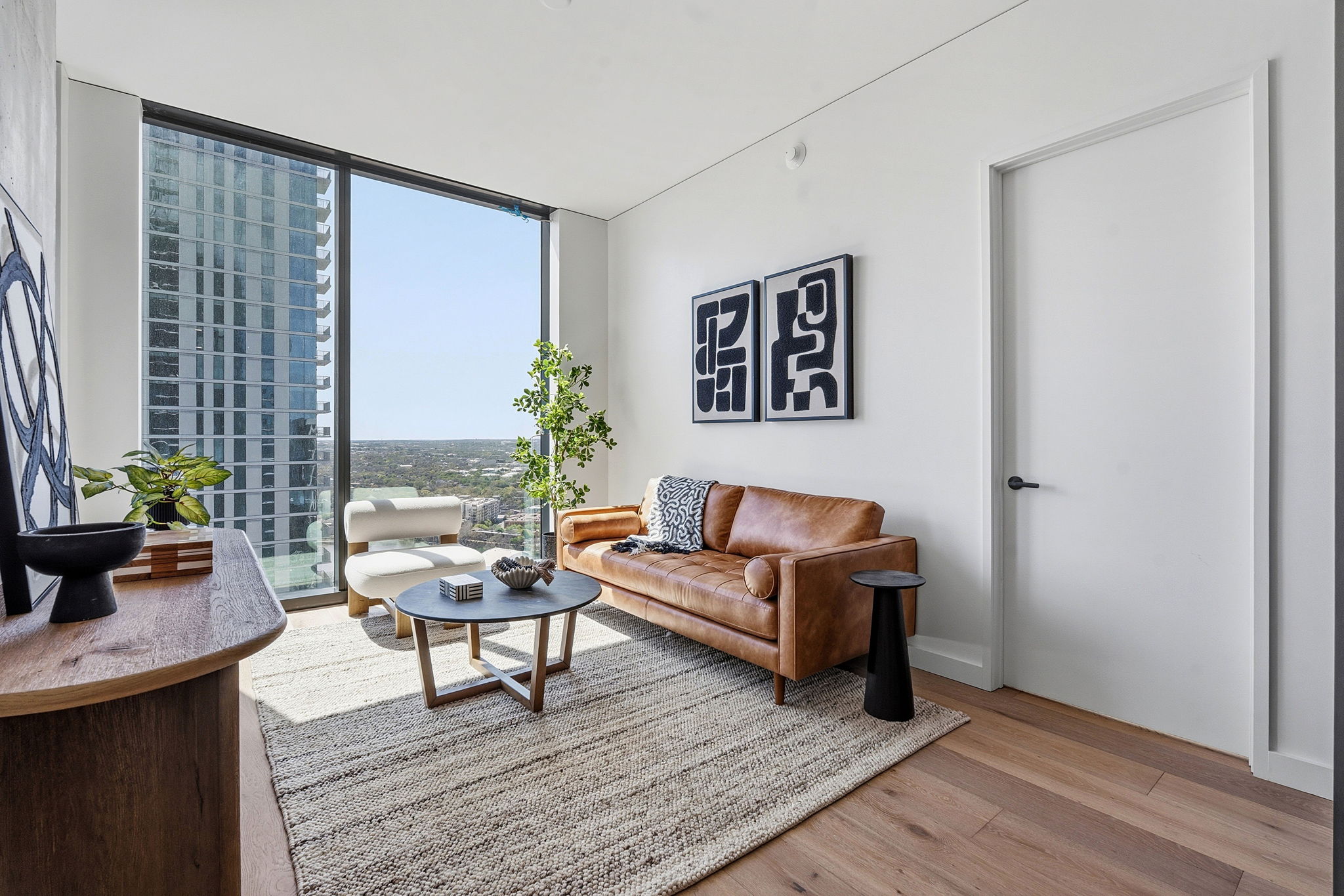 610 Davis Street, Unit 3004 Austin, TX 78701 - Photo 3 of 40 Living area featuring floor to ceiling windows and light wood-type flooring