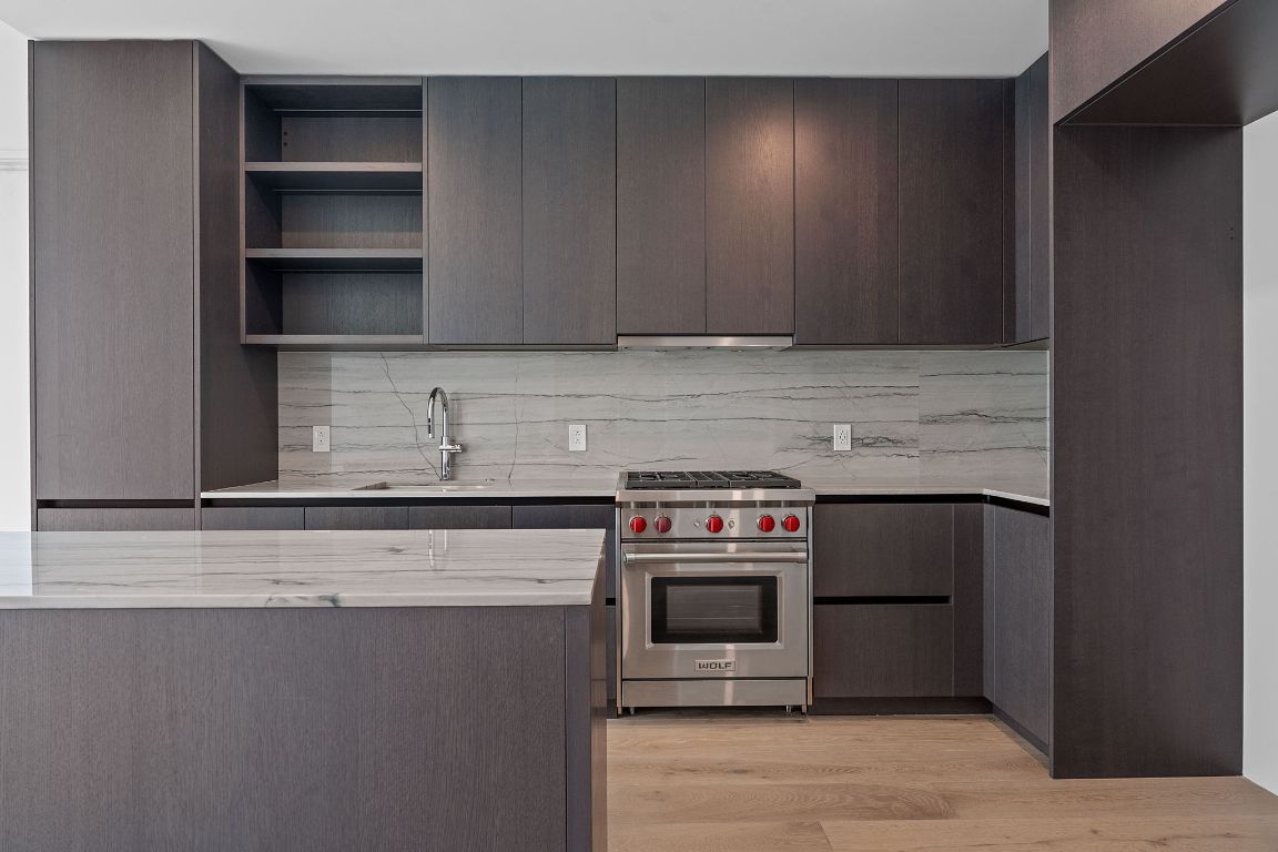 610 Davis Street, Unit 3004 Austin, TX 78701 - Photo 4 of 40 a kitchen with stainless steel appliances granite countertop a stove and a microwave