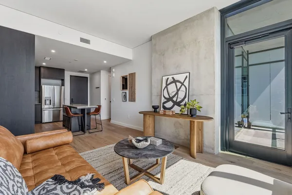 a kitchen with stainless steel appliances granite countertop a refrigerator a sink and a stove