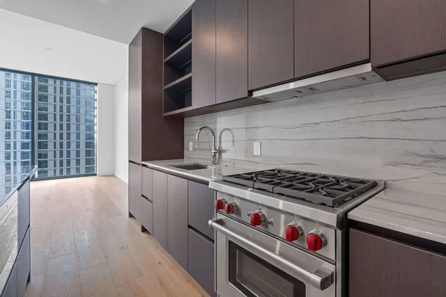 a view of a kitchen with a sink and a refrigerator