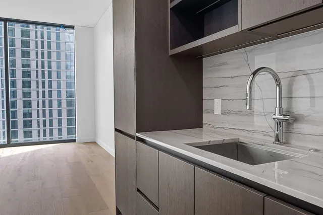 a kitchen with granite countertop a stove and a sink