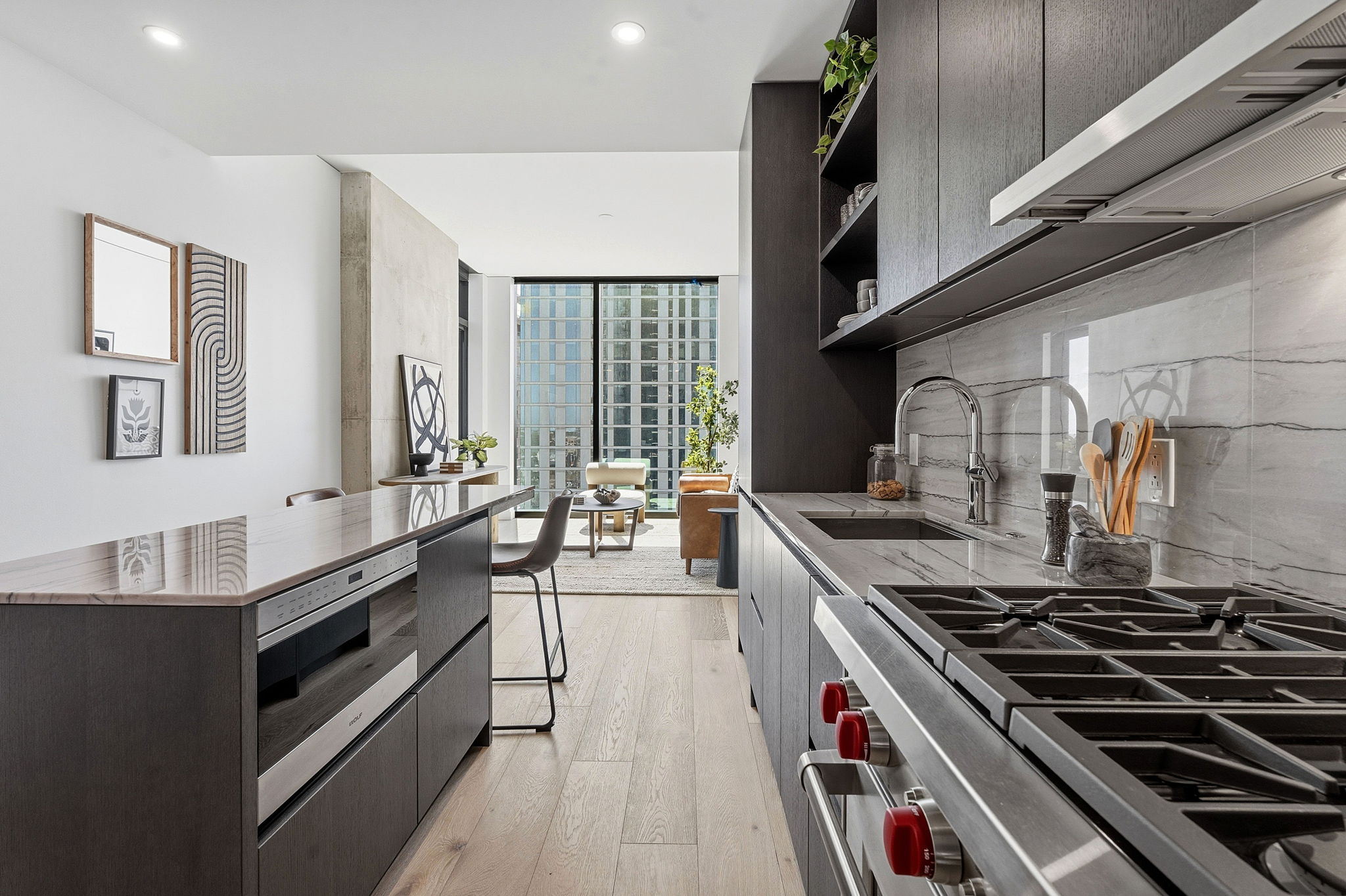 610 Davis Street, Unit 3004 Austin, TX 78701 - Photo 10 of 40 Kitchen with ventilation hood, stainless steel appliances, open shelves, floor to ceiling windows, and modern cabinets