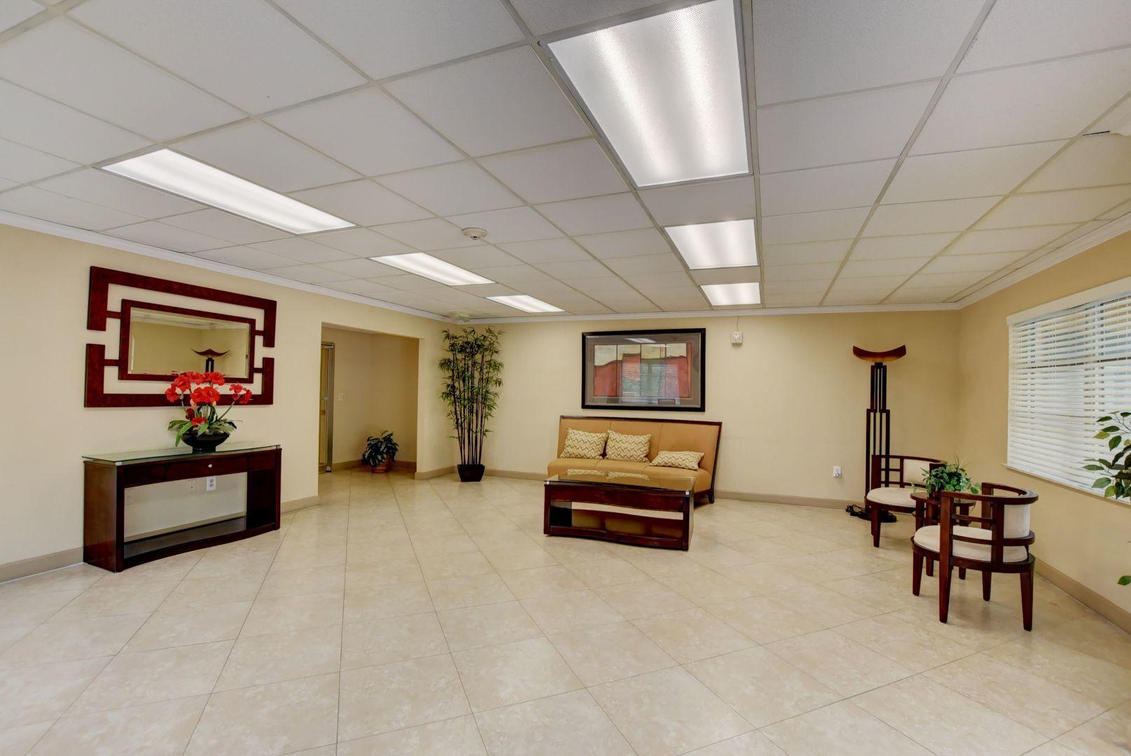 290 West Palmetto Park Road, Unit 304 Boca Raton, FL 33432 - Photo 15 of 27 a living room with furniture gym equipment and a flat screen tv