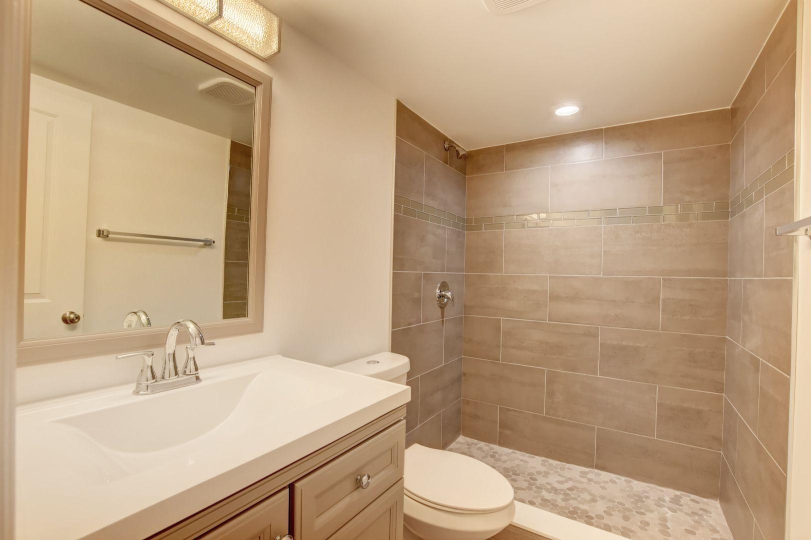 290 West Palmetto Park Road, Unit 304 Boca Raton, FL 33432 - Photo 17 of 27 a bathroom with a sink a toilet and shower