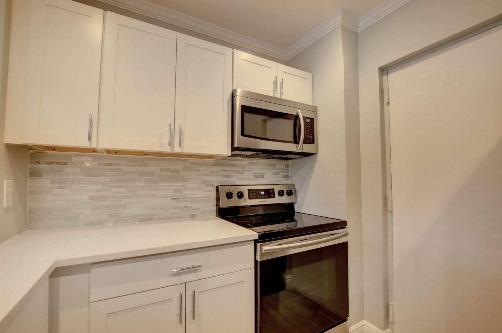 290 West Palmetto Park Road, Unit 304 Boca Raton, FL 33432 - Photo 2 of 27 a kitchen with appliances a sink and cabinets