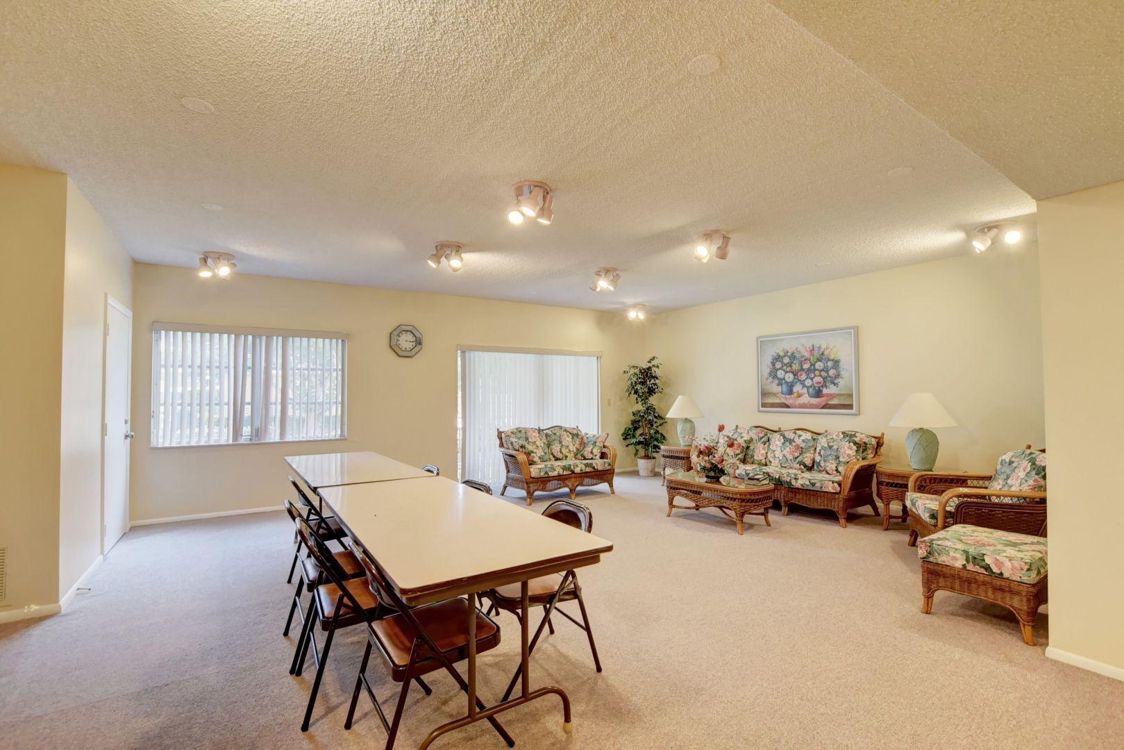 290 West Palmetto Park Road, Unit 304 Boca Raton, FL 33432 - Photo 24 of 27 a living room with furniture and a dining table with chair