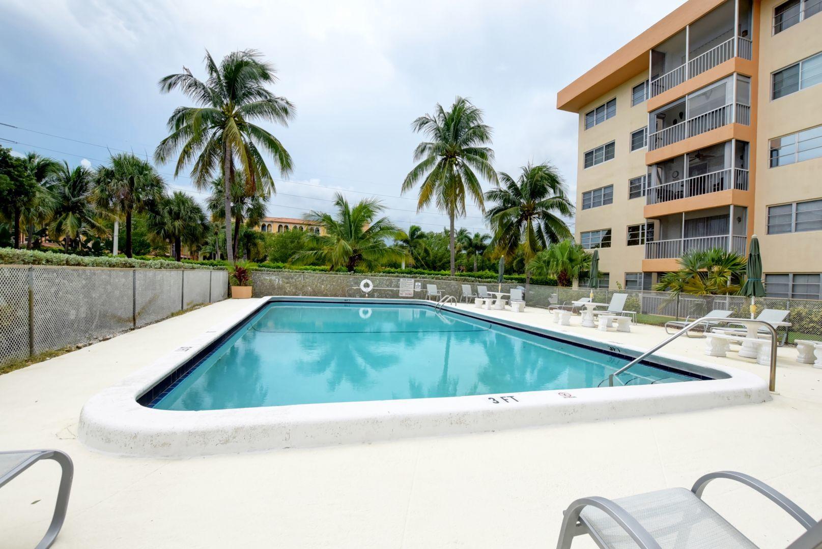290 West Palmetto Park Road, Unit 304 Boca Raton, FL 33432 - Photo 27 of 27 a view of swimming pool with outdoor seating and house in the background
