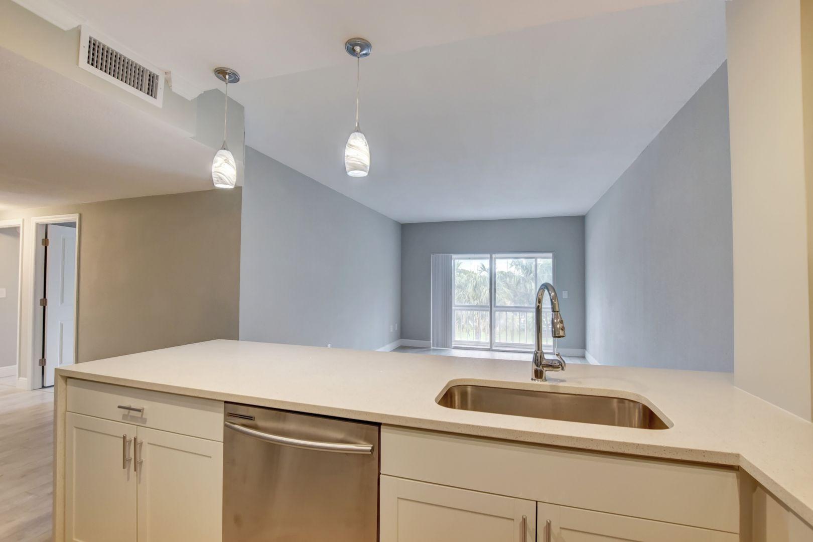 290 West Palmetto Park Road, Unit 304 Boca Raton, FL 33432 - Photo 3 of 27 a kitchen with a sink and a window
