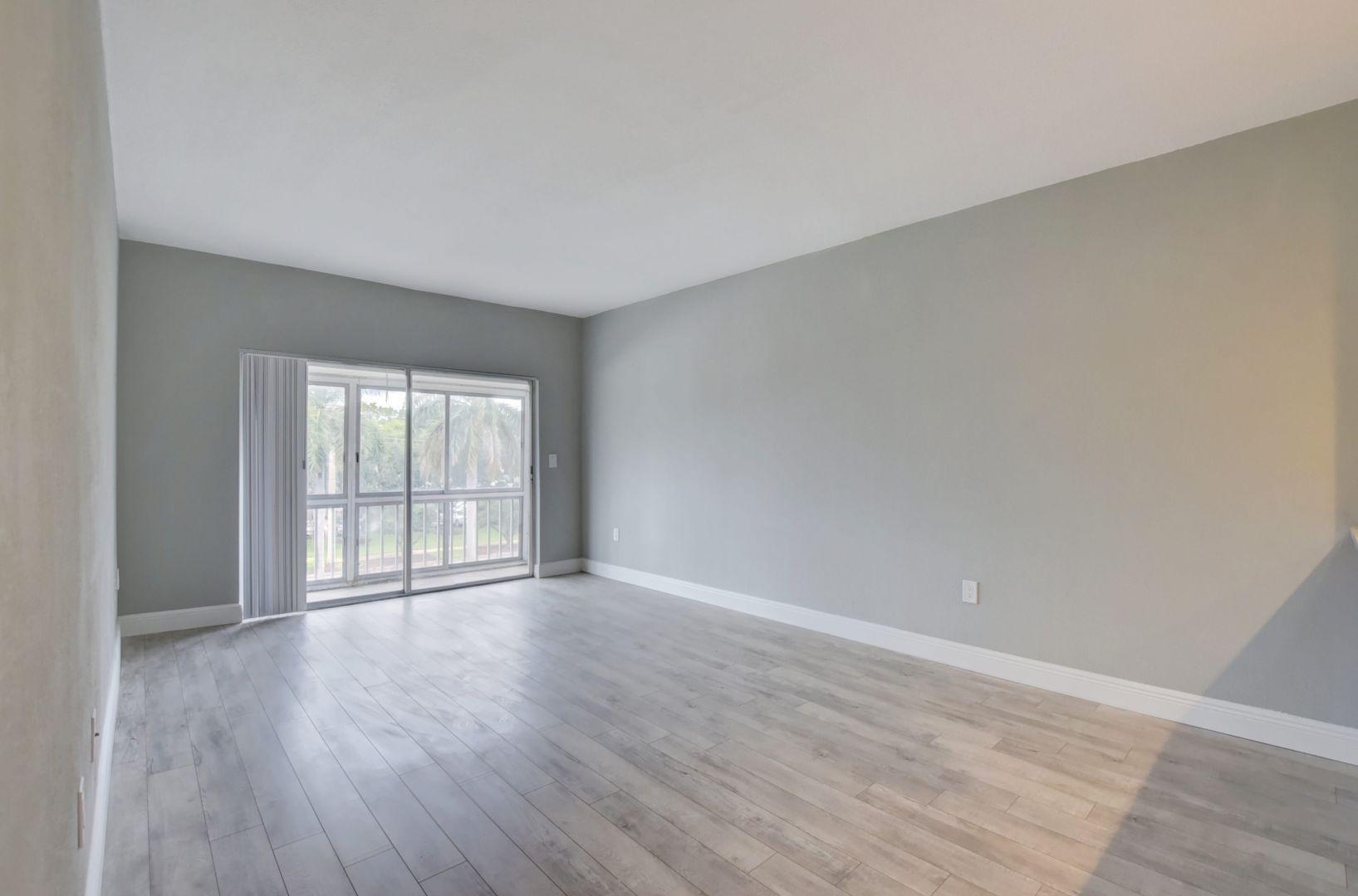 290 West Palmetto Park Road, Unit 304 Boca Raton, FL 33432 - Photo 5 of 27 wooden floor in an empty room with a window