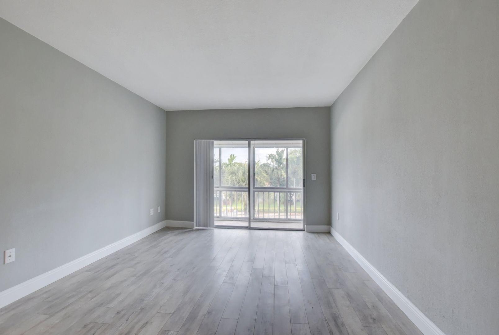 290 West Palmetto Park Road, Unit 304 Boca Raton, FL 33432 - Photo 6 of 27 wooden floor in an empty room with a window