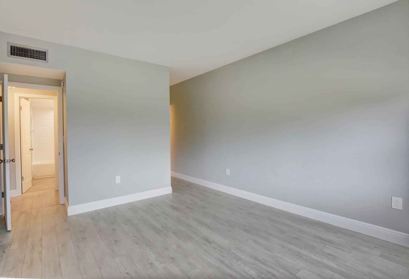 290 West Palmetto Park Road, Unit 304 Boca Raton, FL 33432 - Photo 10 of 27 a view of an empty room with wooden floor and a window