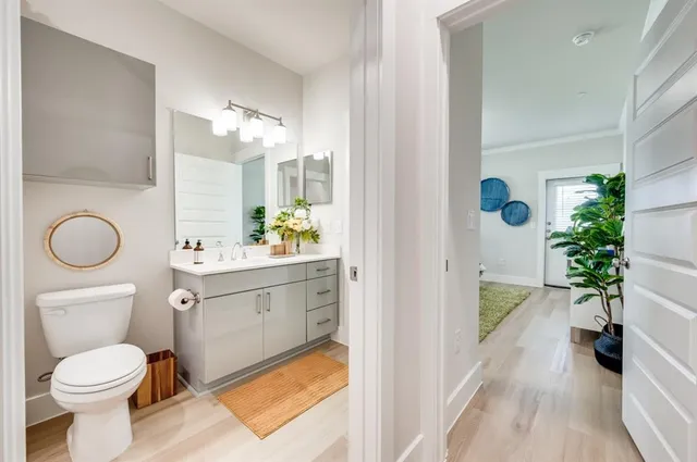 a bathroom with a sink a toilet and a mirror
