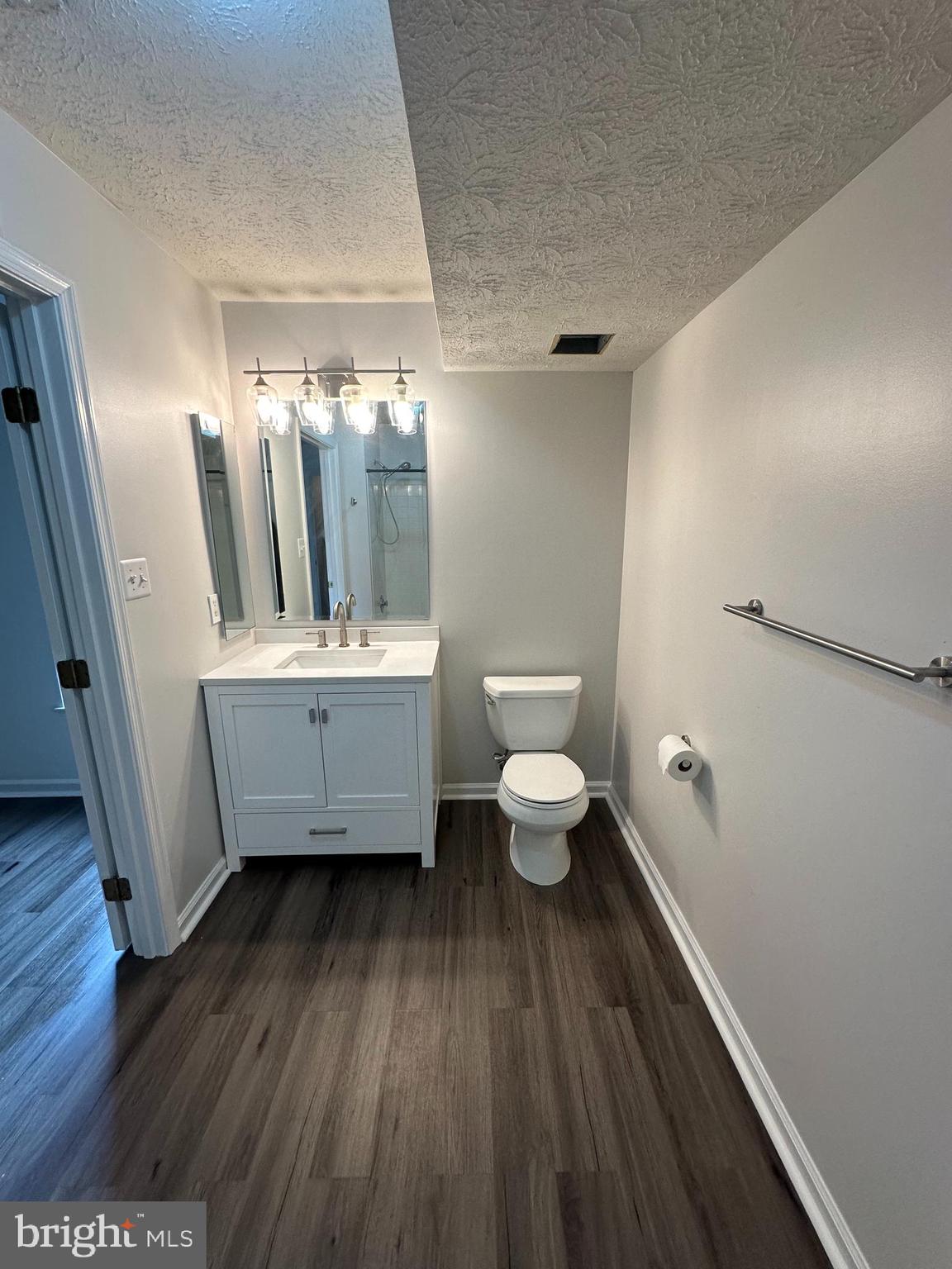 25905 Ridge Manor Drive, Unit C Damascus, MD 20872 - Photo 11 of 13 a bathroom with a sink and a mirror