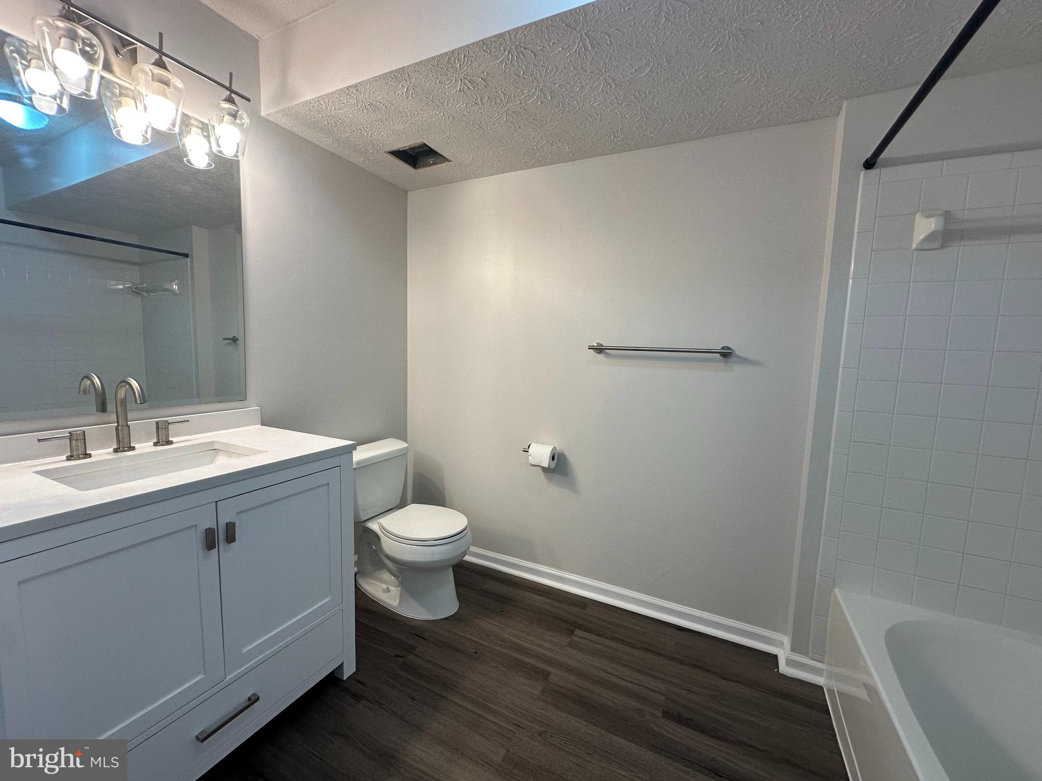 25905 Ridge Manor Drive, Unit C Damascus, MD 20872 - Photo 12 of 13 a bathroom with a sink a toilet and shower
