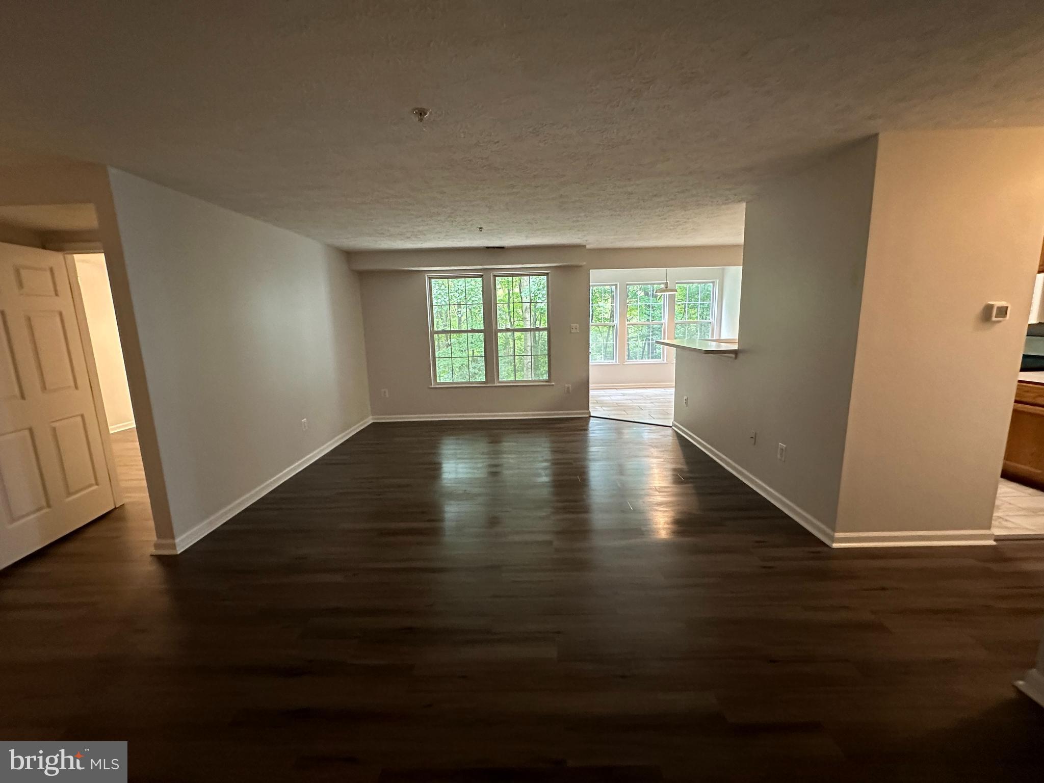 25905 Ridge Manor Drive, Unit C Damascus, MD 20872 - Photo 4 of 13 an empty room with wooden floor and windows
