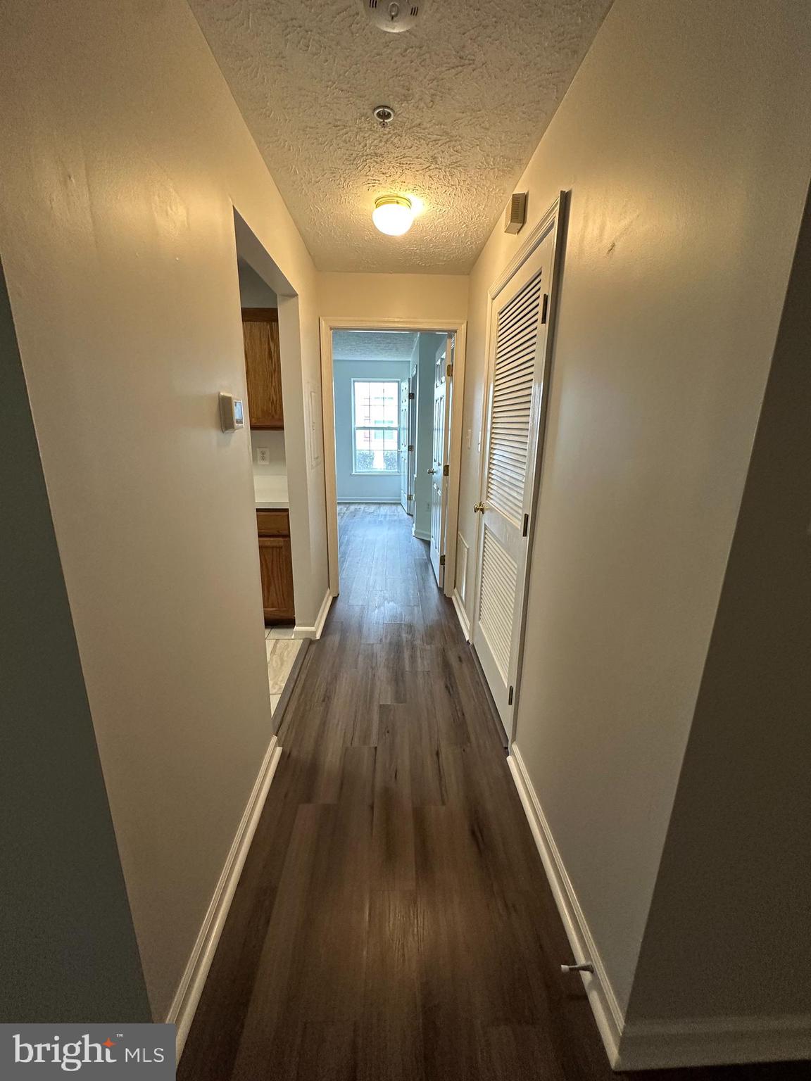 25905 Ridge Manor Drive, Unit C Damascus, MD 20872 - Photo 5 of 13 a view of a hallway with wooden floor