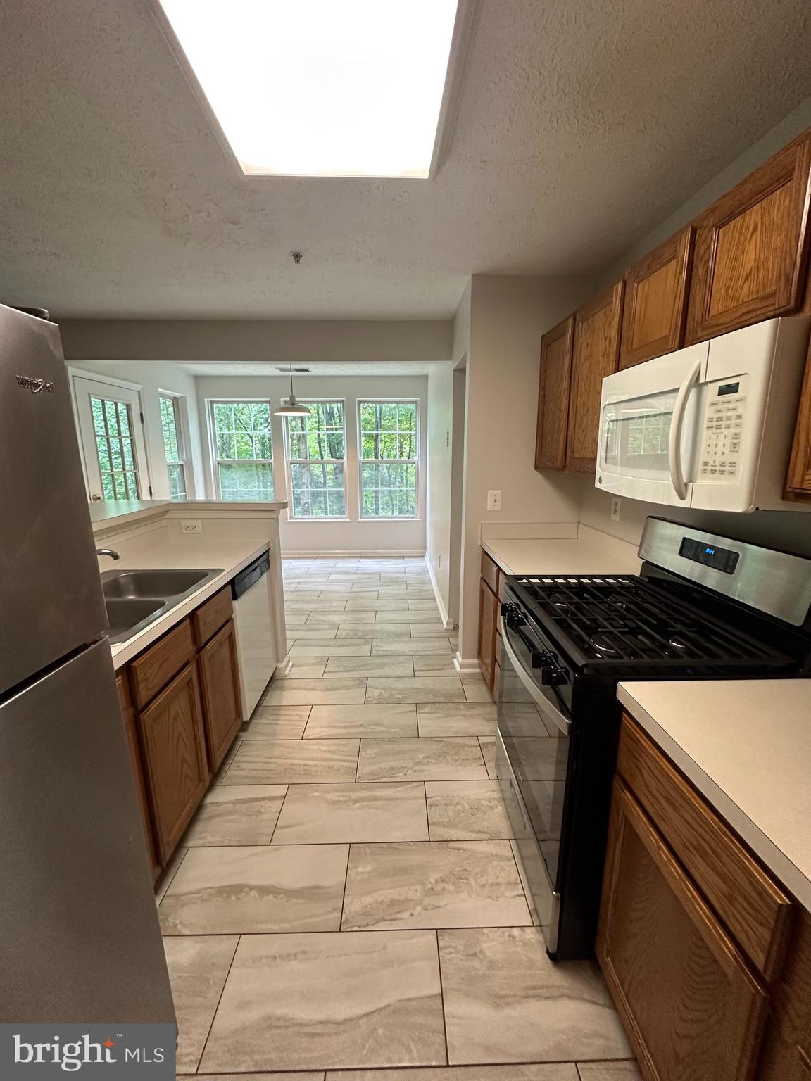 25905 Ridge Manor Drive, Unit C Damascus, MD 20872 - Photo 6 of 13 a kitchen with a stove and a sink