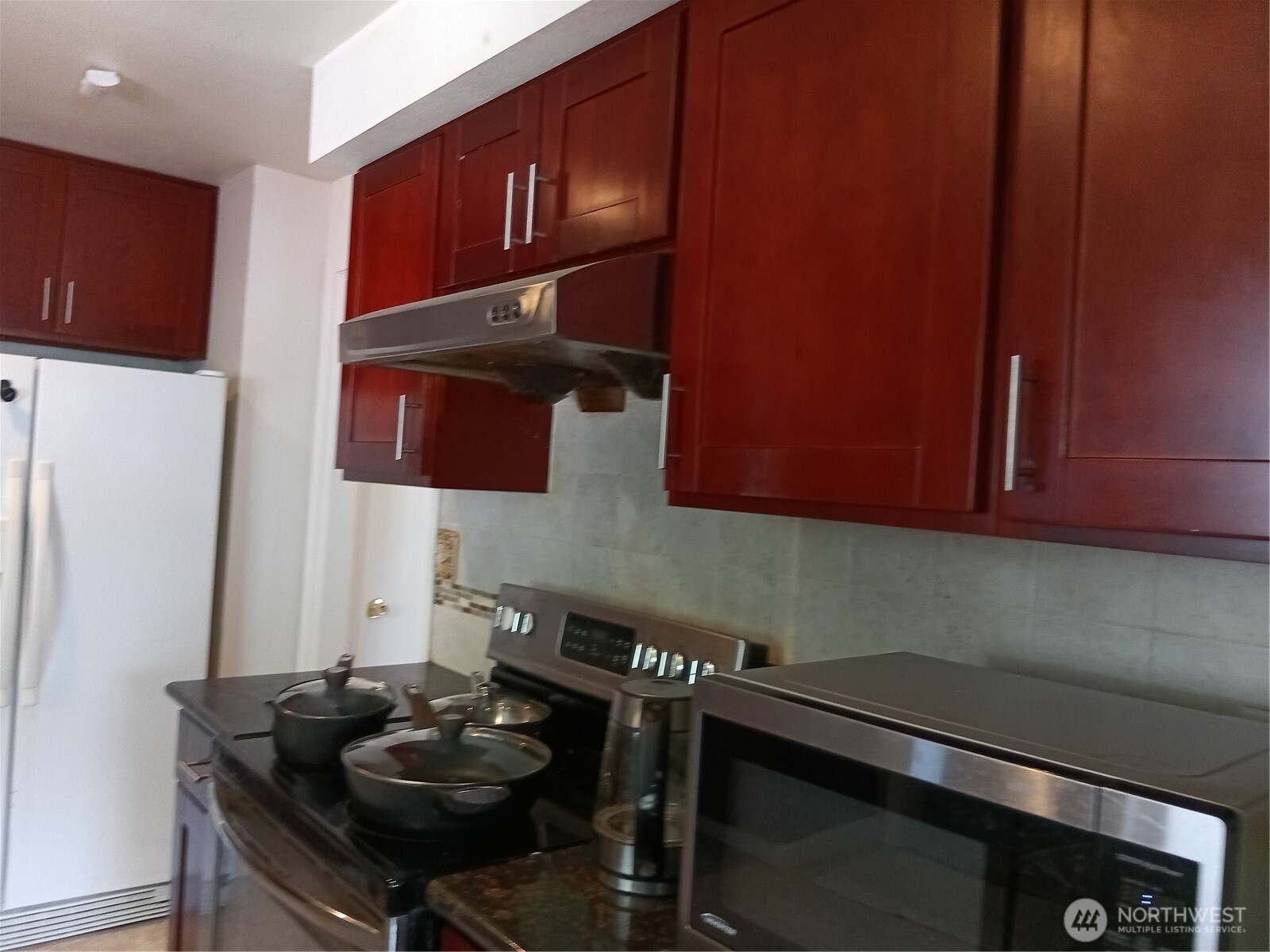 522 Northeast 127th Street Seattle, WA 98125 - Photo 14 of 28 a kitchen with a sink cabinets and stove top oven