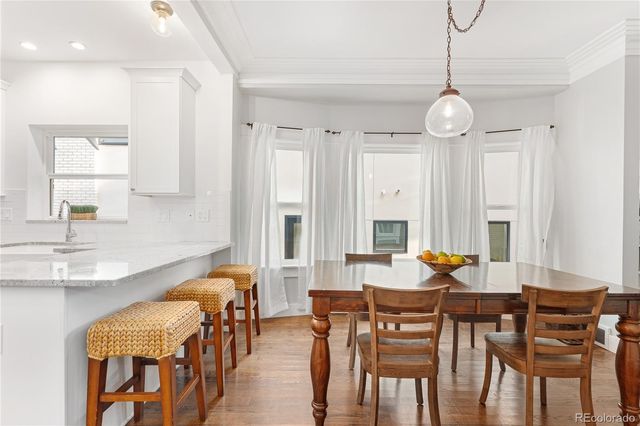 a view of a dining room with furniture and a chandelier