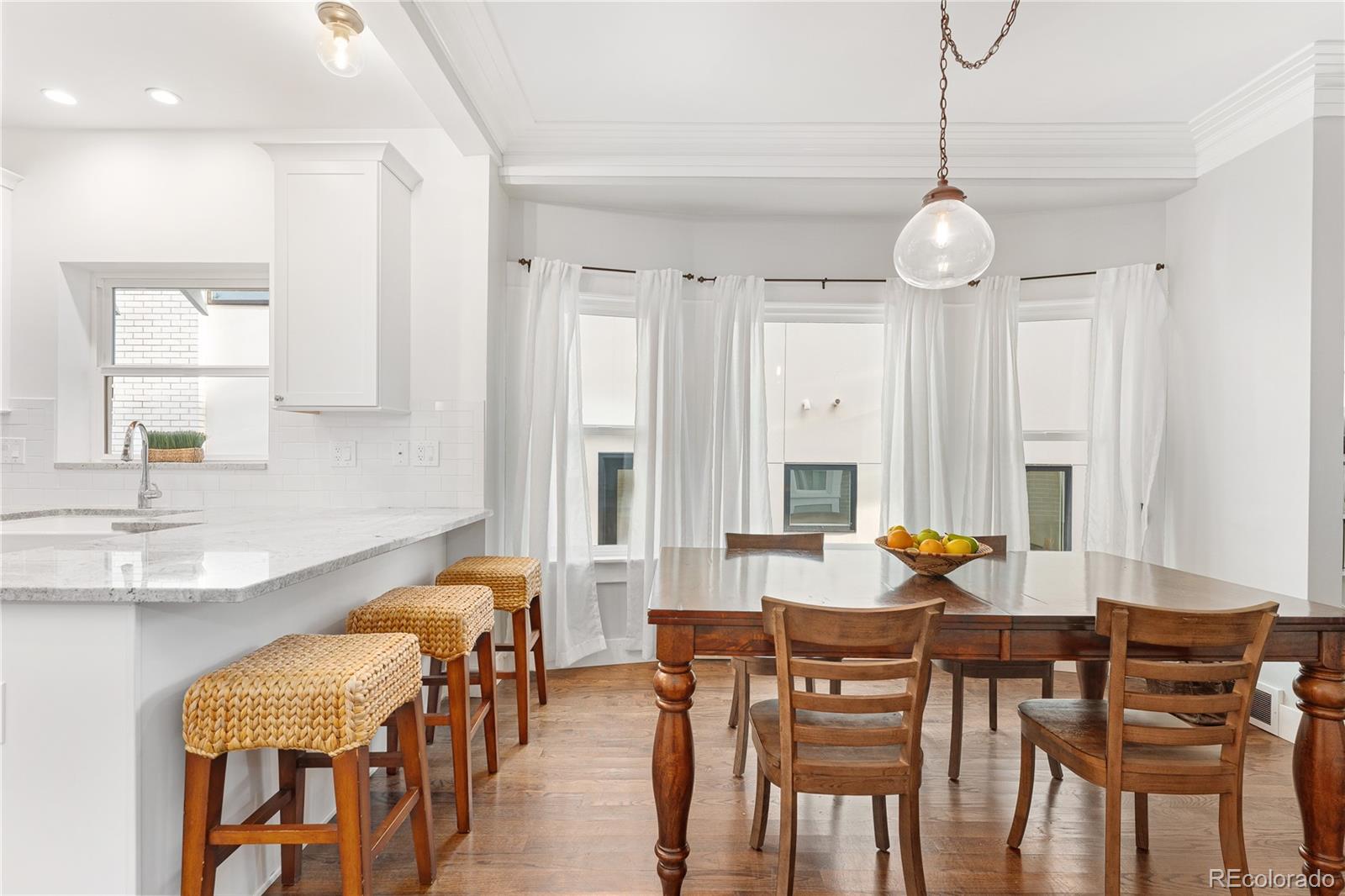 486 South Corona Street Denver, CO 80209 - Photo 11 of 46 a view of a dining room with furniture and a chandelier